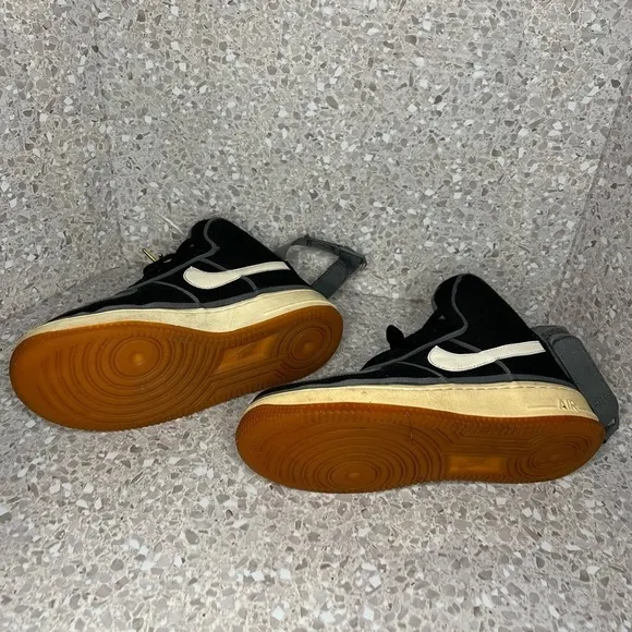 Nike Air Force 1 in Black Canvas. Gold Accents on laces.