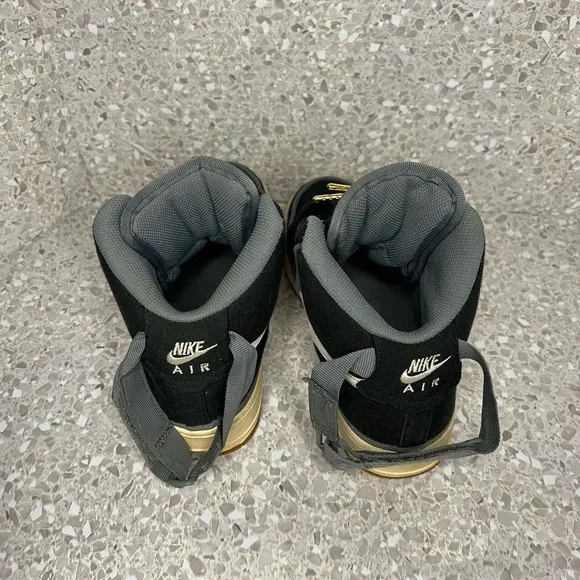 Nike Air Force 1 in Black Canvas. Gold Accents on laces.