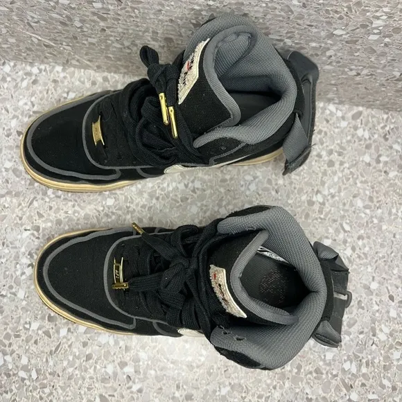 Nike Air Force 1 in Black Canvas. Gold Accents on laces.