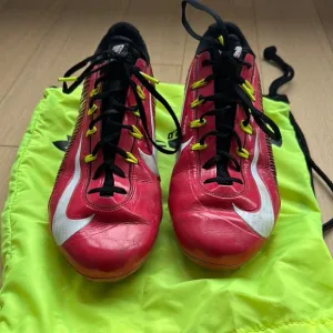 Red and Black Athletic Shoes with White Accents, carrying bag